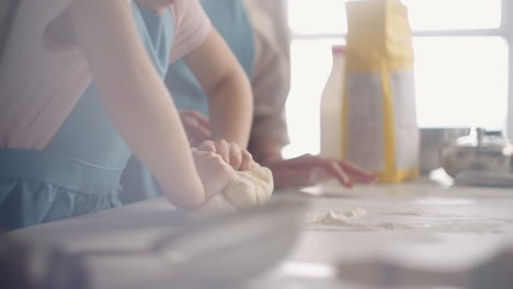 little-girl-and-her-mother-are-cooking-domestic-bread-in-sunday-morning-mom-and-daughter-are-kneading-dough